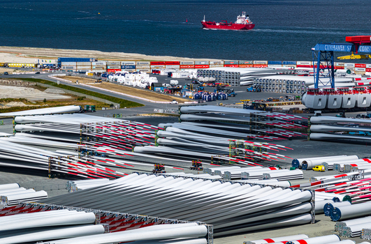Aerial view of Siemens Gamesa Renewable Energy facility with stacked wind turbine blades at the industrial port Cuxhaven Niedersachsen Germany.