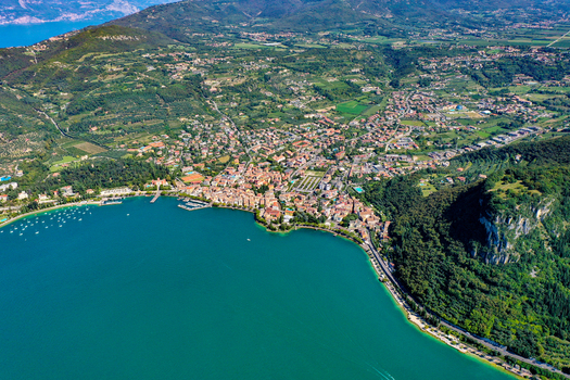 Aerial view of the town of Garda on the shores of Lake Garda featuring turquoise waters lush green hills and historic architecture Garda Veneto Italy. Aerial view of the town of Garda on the shores of Lake Garda featuring turquoise waters lush green hills and historic architecture Garda Veneto Italy.