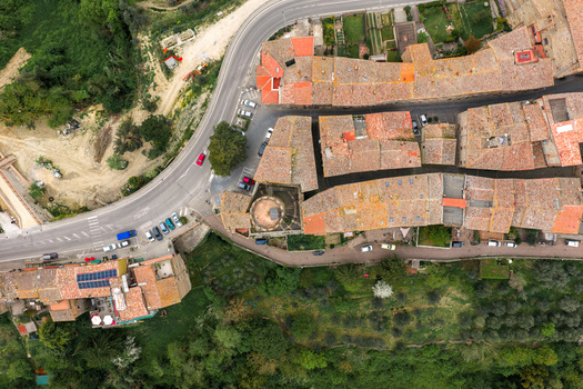 Aerial view of the historic terracotta rooftops a medieval tower and a winding road surrounded by lush greenery and olive groves in Ficulle Umbria Italy. Aerial view of the historic terracotta rooftops a medieval tower and a winding road surrounded by lush greenery and olive groves in Ficulle Umbria Italy.