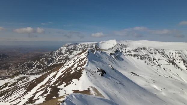 Aerial view of the snowy Moskardshnjukar Trail mountain ridges Iceland. Aerial view of the snowy Moskardshnjukar Trail mountain ridges Iceland.