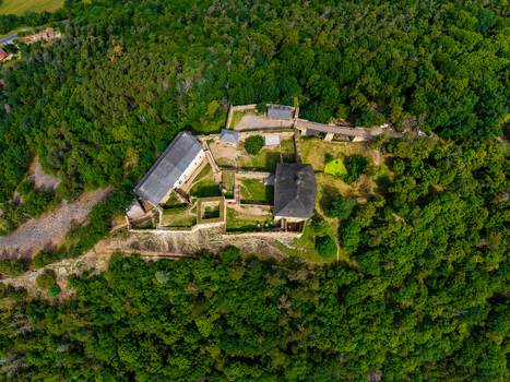 Aerial view of Tocnik Castle a historic medieval fortress surrounded by dense green forests in the Bohemian landscape Tocnik Stredocesky kraj Czechia. Aerial view of Tocnik Castle a historic medieval fortress surrounded by dense green forests in the Bohemian landscape Tocnik Stredocesky kraj Czechia.