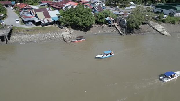 Aerial view of boats on a river in Sarawak Malaysia. Aerial view of boats on a river in Sarawak Malaysia.