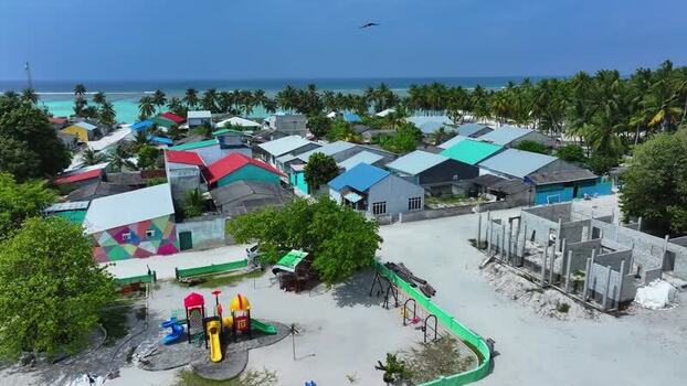 Aerial view of colorful village houses and a playground Maldives. Aerial view of colorful village houses and a playground Maldives.