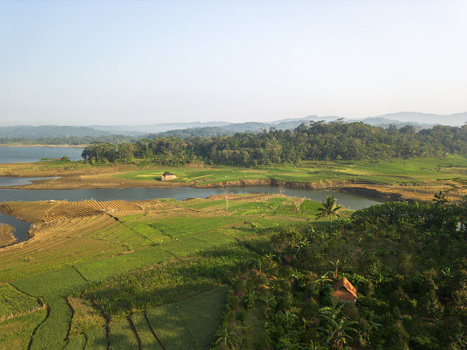 Aerial view of Wadaslintang Reservoir surrounded by lush green agricultural fields terraced crops and dense tropical forests in Wadaslintang Central Java Indonesia. Aerial view of Wadaslintang Reservoir surrounded by lush green agricultural fields terraced crops and dense tropical forests in Wadaslintang Central Java Indonesia.