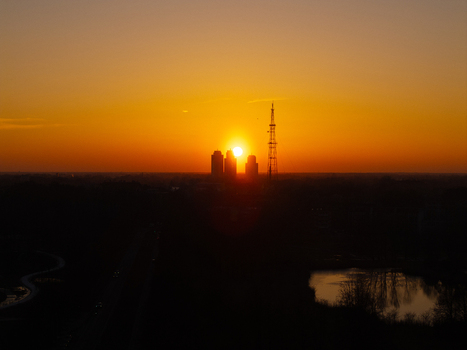 Aerial view of the sunset behind the Panorama Plaza skyscrapers and the communication tower in Riga Latvia.