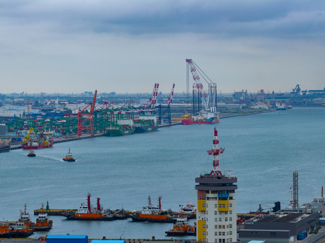 Aerial view of the busy Taichung Port with container ships industrial cranes and tugboats navigating the harbor in Taichung Taichung City Taiwan. Aerial view of the busy Taichung Port with container ships industrial cranes and tugboats navigating the harbor in Taichung Taichung City Taiwan.