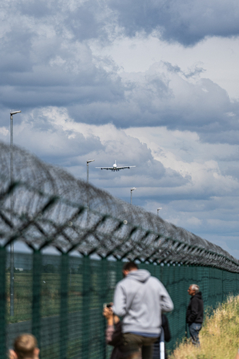Berlin Germany 09 June 2026 View of an Airbus A380 approaching for landing at the ILA Berlin Air Show with spectators watching from behind a chain link fence.