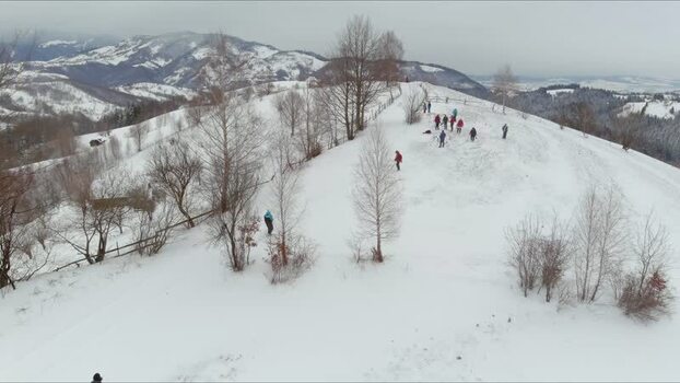 Aerial view of snowy hill with people in Brasov Romania. Aerial view of snowy hill with people in Brasov Romania.