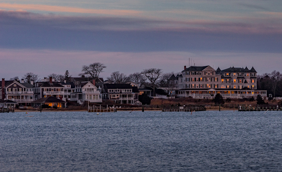 View of Martha s Vineyard waterfront featuring historic coastal architecture and illuminated windows under a twilight sky in Edgartown Massachusetts United States.