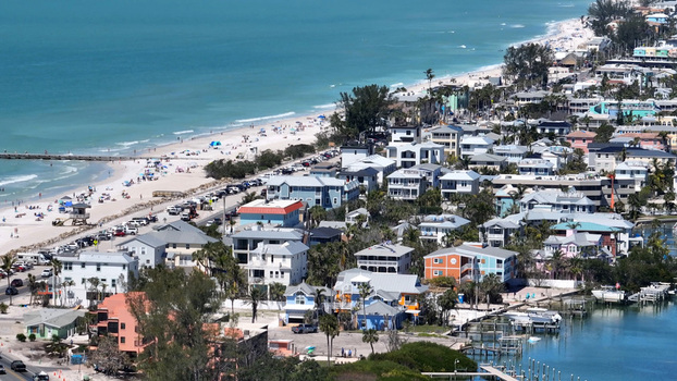 Aerial view of colorful coastal houses sandy beaches turquoise water and boat docks along the shoreline in Bradenton Beach Florida United States. Aerial view of colorful coastal houses sandy beaches turquoise water and boat docks along the shoreline in Bradenton Beach Florida United States.