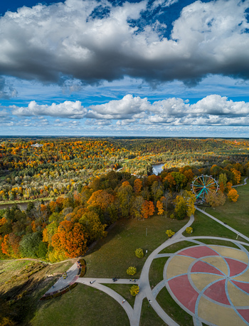 Aerial view of the Sigulda park featuring a colorful ferris wheel vibrant autumn foliage in the Gauja river valley and winding pathways in Sigulda Sigulda Municipality Latvia. Aerial view of the Sigulda park featuring a colorful ferris wheel vibrant autumn foliage in the Gauja river valley and winding pathways in Sigulda Sigulda Municipality Latvia.