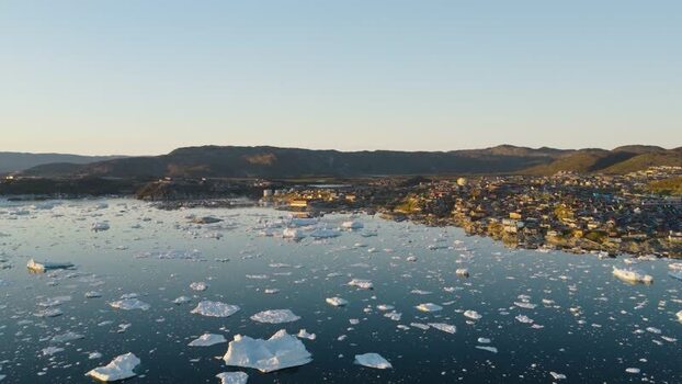 Aerial view of Ilulissat town and icebergs in Greenland. Aerial view of Ilulissat town and icebergs in Greenland.