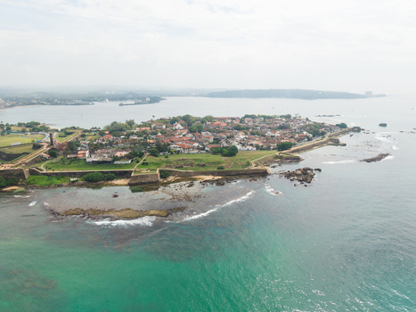 Aerial view of Galle Fort with its historic stone walls red tiled rooftops and lush green lawns along the turquoise ocean Galle Southern Province Sri Lanka. Aerial view of Galle Fort with its historic stone walls red tiled rooftops and lush green lawns along the turquoise ocean Galle Southern Province Sri Lanka.