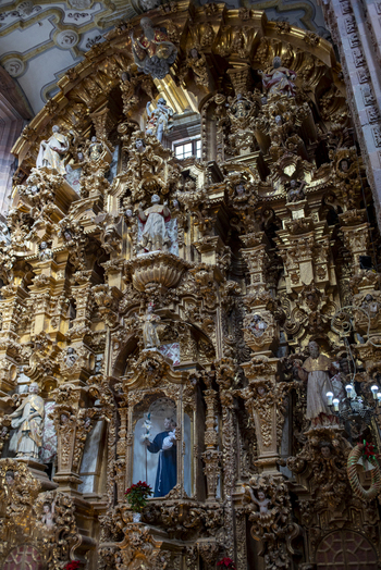 View of the ornate golden baroque altarpiece with intricate wood carvings and religious statues inside a historic church in Guanajuato Guanajuato Mexico. View of the ornate golden baroque altarpiece with intricate wood carvings and religious statues inside a historic church in Guanajuato Guanajuato Mexico.