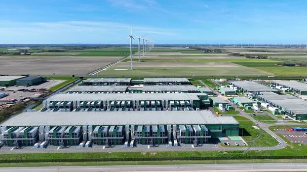 Aerial view of a large data center and wind turbines Netherlands.
