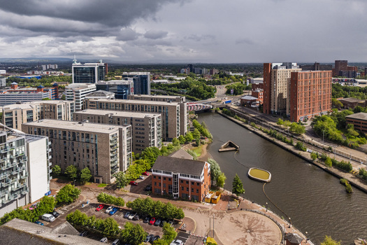 Aerial view of MediaCityUK featuring modern apartment buildings and office blocks along the Manchester Ship Canal in Salford England United Kingdom. Aerial view of MediaCityUK featuring modern apartment buildings and office blocks along the Manchester Ship Canal in Salford England United Kingdom.