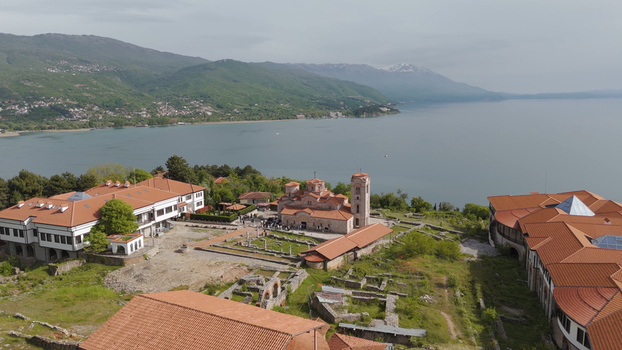 Aerial view of the Church of Saints Clement of Ohrid and Panteleimon with terracotta rooftops overlooking Lake Ohrid under a soft sky. Ohrid Municipality of Ohrid North Macedonia. Aerial view of the Church of Saints Clement of Ohrid and Panteleimon with terracotta rooftops overlooking Lake Ohrid under a soft sky. Ohrid Municipality of Ohrid North Macedonia.