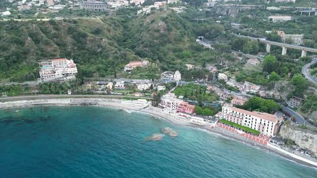 Aerial view of the coastal buildings and hills in Taormina Italy.