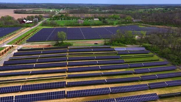 Aerial view of a solar farm with rows of photovoltaic panels United States. Aerial view of a solar farm with rows of photovoltaic panels United States.