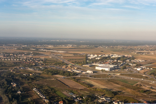 Aerial view of the intricate network of roads and buildings contrasting against the open fields Pruszków Masovian Voivodeship Poland. Aerial view of the intricate network of roads and buildings contrasting against the open fields Pruszków Masovian Voivodeship Poland.