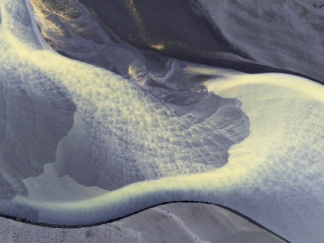 Aerial view of the intricate braided patterns of a glacial river delta with sediment rich water flowing over volcanic sand in Hallgeirseyjarvegur Rangarthing eystra Iceland. Aerial view of the intricate braided patterns of a glacial river delta with sediment rich water flowing over volcanic sand in Hallgeirseyjarvegur Rangarthing eystra Iceland.