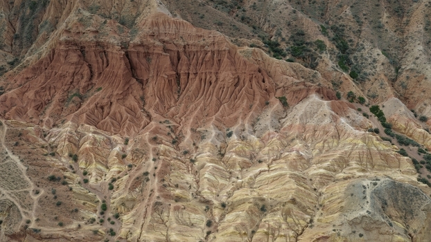 Aerial view of the dramatic red sandstone rock formations deep canyons and eroded cliffs of Jety Oguz Issyk Kul Region Kyrgyzstan. Aerial view of the dramatic red sandstone rock formations deep canyons and eroded cliffs of Jety Oguz Issyk Kul Region Kyrgyzstan.