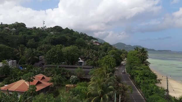Aerial view of Mahe coastline and tropical road Seychelles.
