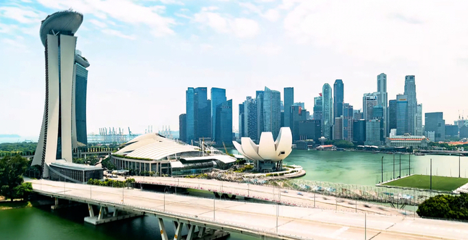 Singapore Singapore 28 September 2026 Aerial view of the ArtScience Museum and Marina Bay skyline featuring modern skyscrapers the Helix Bridge and calm bay waters.