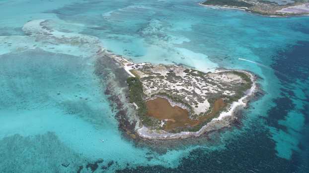 Aerial view of Los Roques archipelago featuring a small island with a central lagoon white beaches and turquoise Caribbean waters. Los Roques Dependencias Federales Venezuela. Aerial view of Los Roques archipelago featuring a small island with a central lagoon white beaches and turquoise Caribbean waters. Los Roques Dependencias Federales Venezuela.