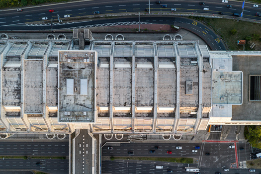 Aerial view of the ICC Berlin a prominent example of brutalist architecture with its massive concrete roof structure and geometric design next to a highway in Berlin Berlin Germany. Aerial view of the ICC Berlin a prominent example of brutalist architecture with its massive concrete roof structure and geometric design next to a highway in Berlin Berlin Germany.