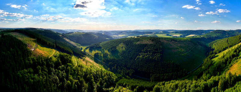Aerial view of the lush green valley and dense forests surrounding the landscape of Eslohe North Rhine Westphalia Germany. Aerial view of the lush green valley and dense forests surrounding the landscape of Eslohe North Rhine Westphalia Germany.