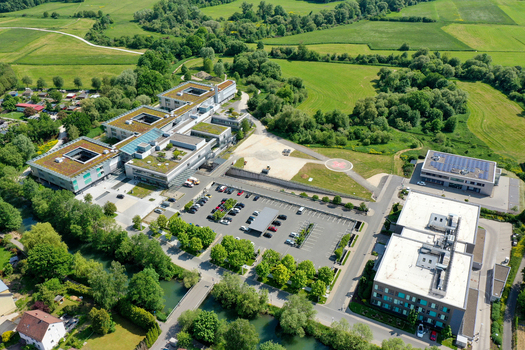 Aerial view of Klinikum Forchheim Frankische Schweiz gGmbH featuring modern hospital buildings with green roofs parking area and helipad in Forchheim Bayern Germany. Aerial view of Klinikum Forchheim Frankische Schweiz gGmbH featuring modern hospital buildings with green roofs parking area and helipad in Forchheim Bayern Germany.