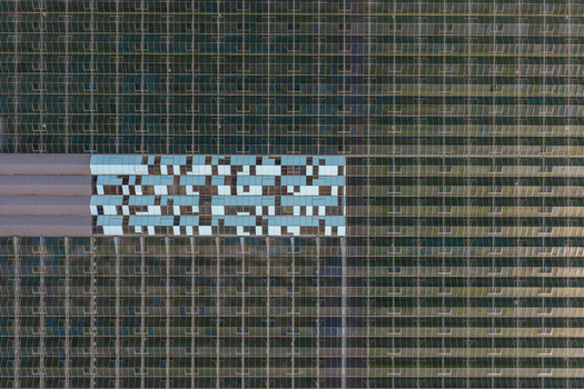 Aerial view of a large greenhouse complex with glass roofs and a geometric pattern of panels in Hrusky South Moravian Region Czechia. Aerial view of a large greenhouse complex with glass roofs and a geometric pattern of panels in Hrusky South Moravian Region Czechia.