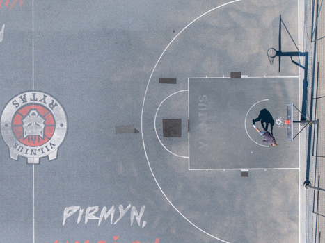 Vilnius Lithuania 20 April 2026 Aerial view of a basketball court in Chiune Sugihara Sakura Park featuring a player standing on the court with a long shadow cast on the pavement. Vilnius Lithuania 20 April 2026 Aerial view of a basketball court in Chiune Sugihara Sakura Park featuring a player standing on the court with a long shadow cast on the pavement.