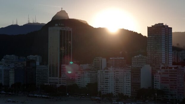 Aerial view of Christ the Redeemer and city skyline at sunset Brazil.