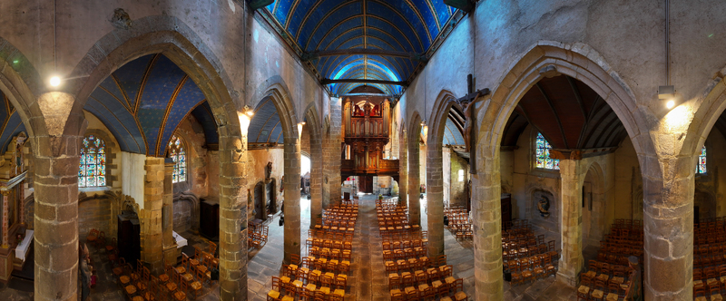 Aerial view of Eglise Saint Melaine de Morlaix featuring a blue vaulted ceiling with gold stars stone arches and rows of wooden pews in Morlaix Bretagne France. Aerial view of Eglise Saint Melaine de Morlaix featuring a blue vaulted ceiling with gold stars stone arches and rows of wooden pews in Morlaix Bretagne France.