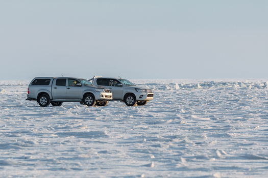 View of two silver pickup trucks parked on the frozen icy surface of Lake Baikal in Severobaykalsk Buryatia Russia. View of two silver pickup trucks parked on the frozen icy surface of Lake Baikal in Severobaykalsk Buryatia Russia.