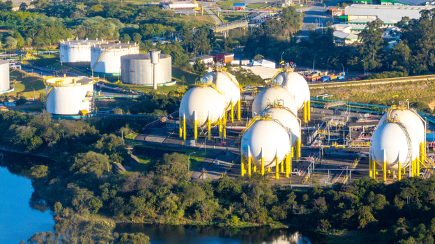 Aerial view of a petrochemical complex with large spherical storage tanks and industrial infrastructure surrounded by lush greenery in Santo Andre State of Sao Paulo Brazil.
