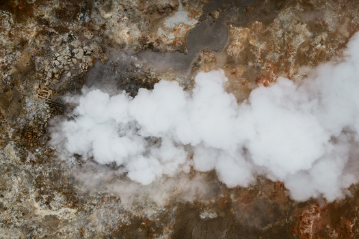 Aerial view of geothermal steam rising from volcanic ground with rocky terrain and mineral deposits in Reykjavik Reykjavikurborg Iceland. Aerial view of geothermal steam rising from volcanic ground with rocky terrain and mineral deposits in Reykjavik Reykjavikurborg Iceland.