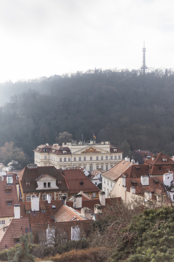 View of historic red tiled rooftops and the Petrin Lookout Tower on a misty hill Prague Prague Czechia. View of historic red tiled rooftops and the Petrin Lookout Tower on a misty hill Prague Prague Czechia.
