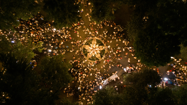 Aerial view of a large crowd gathered around an illuminated central fountain at night in Sremska Mitrovica Serbia. Aerial view of a large crowd gathered around an illuminated central fountain at night in Sremska Mitrovica Serbia.
