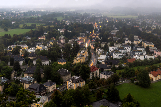Aerial view of the city of Salzburg with historic buildings lush green spaces and roads winding through the urban landscape in Salzburg Salzburg Austria. Aerial view of the city of Salzburg with historic buildings lush green spaces and roads winding through the urban landscape in Salzburg Salzburg Austria.