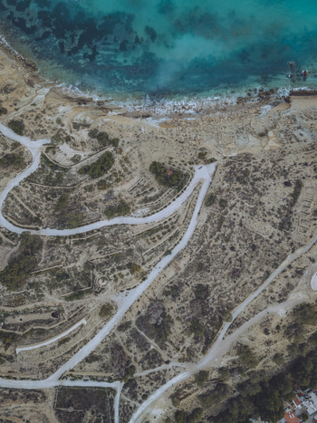 Aerial view of Santuari iber i roma de la Malladeta with winding paths rocky cliffs and turquoise Mediterranean waters in La Vila Joiosa Comunidad Valenciana Spain. Aerial view of Santuari iber i roma de la Malladeta with winding paths rocky cliffs and turquoise Mediterranean waters in La Vila Joiosa Comunidad Valenciana Spain.