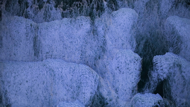 Aerial view of powerful ocean waves crashing with white foam and spray creating abstract textures on the deep blue water Cape Town Western Cape South Africa. Aerial view of powerful ocean waves crashing with white foam and spray creating abstract textures on the deep blue water Cape Town Western Cape South Africa.