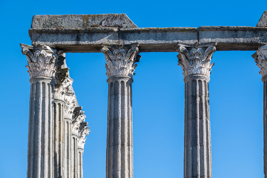 Evora Portugal 09 September 2026 View of the ancient Corinthian columns of the Roman Temple of Evora against a clear blue sky in Portugal. Evora Portugal 09 September 2026 View of the ancient Corinthian columns of the Roman Temple of Evora against a clear blue sky in Portugal.