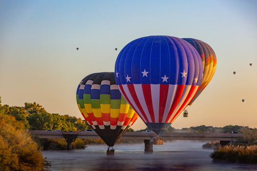 Albuquerque United States 11 October 2017 View of hot air balloons floating over the Rio Grande mist rising from the water as the sun paints the sky with hues of dawn.. Albuquerque United States 11 October 2017 View of hot air balloons floating over the Rio Grande mist rising from the water as the sun paints the sky with hues of dawn..