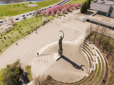 Aerial view of the National Gallery of Art and the surrounding plaza with the sculpture in spring featuring blooming cherry trees and people walking in Vilnius Vilniaus apskritis Lithuania. Aerial view of the National Gallery of Art and the surrounding plaza with the sculpture in spring featuring blooming cherry trees and people walking in Vilnius Vilniaus apskritis Lithuania.