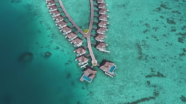 Aerial view of overwater bungalows and coral reefs Maldives. Aerial view of overwater bungalows and coral reefs Maldives.