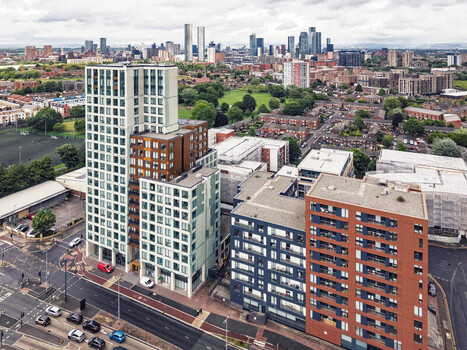 Aerial view of MediaCityUK and modern residential apartment buildings with glass and brick facades overlooking the urban landscape under a cloudy sky Salford England United Kingdom. Aerial view of MediaCityUK and modern residential apartment buildings with glass and brick facades overlooking the urban landscape under a cloudy sky Salford England United Kingdom.
