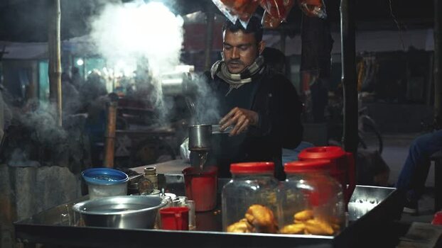 View of a vendor preparing hot tea at a night market Bangladesh. View of a vendor preparing hot tea at a night market Bangladesh.
